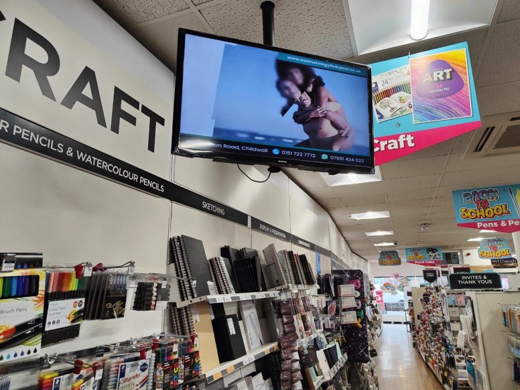 A Direct Digital remote device suspended from the ceiling of a retail outlet